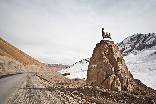 A statue of a headless goat stands atop a boulder along the Southern Corridor highway that leads to the Irkeshtam Border Pass with China. The headless goat carcass is used in a game of polo in Central Asia, called buzkashi.